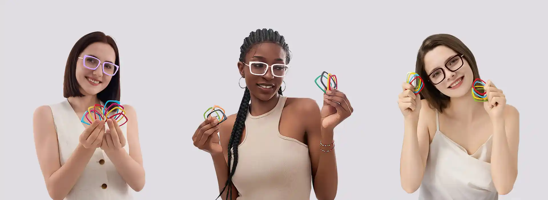 Homepage banner with three diverse models wearing XCombo glasses and holding colorful interchangeable Top Frames