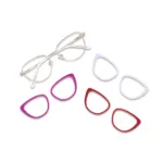XCombo Aura champagne gold cat-eye metal base frame with three interchangeable solid color eyewear toppers in pink, red and light purple.